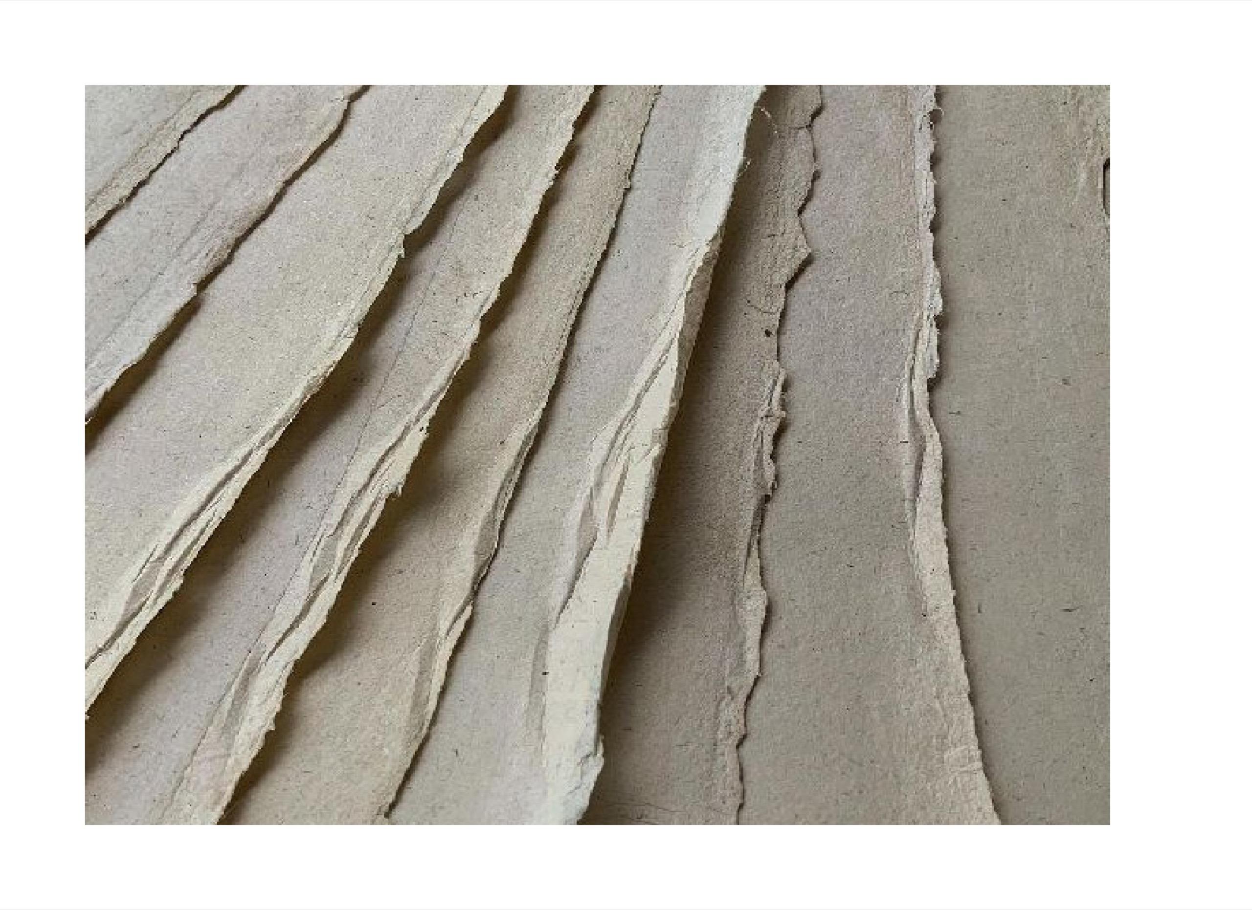 Layered edges of handmade paper in warm neutral tones, from the museum capstone thesis
