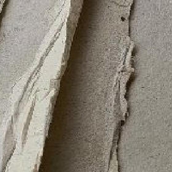 Square detail of the Journey material study: deckled handmade-paper edges over a flecked beige sheet.